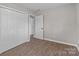 A bedroom with fresh paint, luxury vinyl plank flooring, and an updated closet at 880 Legion Club Rd, Salisbury, NC 28146