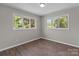 Cozy bedroom filled with natural light from the windows, hardwood floors and neutral walls at 880 Legion Club Rd, Salisbury, NC 28146