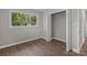A bedroom with fresh paint, luxury vinyl plank flooring, and an open closet at 880 Legion Club Rd, Salisbury, NC 28146