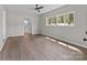 Light-filled bedroom boasts hardwood floors, a ceiling fan, and windows with views at 880 Legion Club Rd, Salisbury, NC 28146
