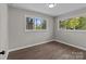 An open and airy bedroom featuring updated paint, flooring, and window views at 880 Legion Club Rd, Salisbury, NC 28146