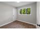 Bright bedroom featuring luxury vinyl plank flooring, fresh paint, and a nice window view at 880 Legion Club Rd, Salisbury, NC 28146
