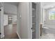 A recently renovated hallway with luxury vinyl plank flooring and access to an updated bathroom at 880 Legion Club Rd, Salisbury, NC 28146