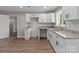 Well-lit kitchen featuring white cabinets, granite countertops, and a stainless steel sink at 880 Legion Club Rd, Salisbury, NC 28146