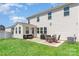Exterior view of backyard with patio, dining set, grill, and sunroom at 9102 Buckley Ct, Charlotte, NC 28269