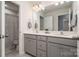 Bathroom featuring double sinks with gray vanity and modern fixtures at 9102 Buckley Ct, Charlotte, NC 28269