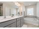 Bright bathroom with double vanity and soaking tub at 9102 Buckley Ct, Charlotte, NC 28269