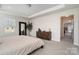 Bedroom featuring neutral carpet, decorative tray ceiling, and wooden dresser at 9102 Buckley Ct, Charlotte, NC 28269