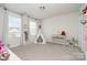 Bright bedroom featuring a playful teepee, neutral walls, and plush carpet at 9102 Buckley Ct, Charlotte, NC 28269