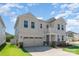 Attractive two-story home boasts manicured lawn, charming balcony, and attached two-car garage at 9102 Buckley Ct, Charlotte, NC 28269