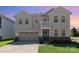 Inviting two-story home with a well-manicured lawn and a charming covered front porch at 9102 Buckley Ct, Charlotte, NC 28269