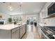 Bright, open kitchen featuring a center island with quartz countertops and stainless steel appliances at 9102 Buckley Ct, Charlotte, NC 28269