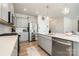 Modern kitchen with stainless steel appliances, gray cabinets, and an island with a sink at 9102 Buckley Ct, Charlotte, NC 28269