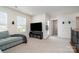 Living area featuring light-gray sofa, neutral carpet, and flat screen TV at 9102 Buckley Ct, Charlotte, NC 28269