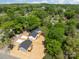 This aerial view highlights three charming homes surrounded by lush greenery in a peaceful, residential neighborhood at 104 Cleveland Ave, Albemarle, NC 28001