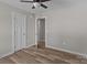 Spacious bedroom with wood-look floors, neutral paint, ceiling fan, and closet at 104 Cleveland Ave, Albemarle, NC 28001