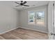 Bright bedroom featuring a large window, wood-look flooring, and neutral colored walls at 104 Cleveland Ave, Albemarle, NC 28001