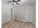 Spacious bedroom featuring an open doorway, wood-look flooring, and neutral colored walls at 104 Cleveland Ave, Albemarle, NC 28001