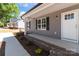 Charming front porch with brick accents and stylish lighting, creating an inviting and welcoming entryway at 104 Cleveland Ave, Albemarle, NC 28001
