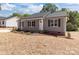 Charming single-story home featuring a well-manicured lawn and inviting front porch, perfect for relaxing evenings at 104 Cleveland Ave, Albemarle, NC 28001