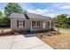 Charming single-story home featuring a well-manicured lawn and inviting front porch, perfect for relaxing evenings at 104 Cleveland Ave, Albemarle, NC 28001