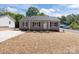 Charming single-story home featuring a well-manicured lawn and inviting front porch, perfect for relaxing evenings at 104 Cleveland Ave, Albemarle, NC 28001