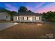 Charming single-story home featuring a well-manicured lawn and inviting front porch, perfect for relaxing evenings at 104 Cleveland Ave, Albemarle, NC 28001