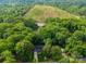Aerial view of a house in lush greenery near a pond at 11104 Pine Grove Ave, Mint Hill, NC 28227