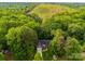 Aerial view of a charming home nestled among lush greenery and a landscaped yard at 11104 Pine Grove Ave, Mint Hill, NC 28227
