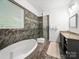 Beautiful bathroom with a soaking tub, glass-enclosed shower, marble tile, and granite countertops at 11104 Pine Grove Ave, Mint Hill, NC 28227