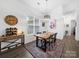 Open dining area with hardwood flooring, rustic table, and natural light at 11104 Pine Grove Ave, Mint Hill, NC 28227