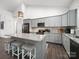 Modern kitchen featuring granite countertops, stainless steel appliances, and gray cabinets at 11104 Pine Grove Ave, Mint Hill, NC 28227