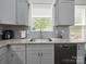 Bright kitchen with a large sink, granite countertops, stainless steel appliances, and ample cabinet space at 11104 Pine Grove Ave, Mint Hill, NC 28227