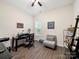 Well-lit home office with a ceiling fan, desk, chair, and a serene window view at 11104 Pine Grove Ave, Mint Hill, NC 28227