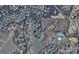 An aerial view of a residential area with single Gathering homes and mature trees around a lake at 116 Anderson Farm Ct, Mooresville, NC 28117