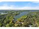 Aerial view of a lakefront community, surrounded by mature trees, and boat docks on a sunny day at 116 Anderson Farm Ct, Mooresville, NC 28117