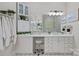 Well-lit bathroom with dual sinks, vanity area, mirror, and ample storage at 116 Anderson Farm Ct, Mooresville, NC 28117