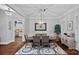 Elegant dining room featuring hardwood floors, modern lighting, and seamless access to the kitchen at 116 Anderson Farm Ct, Mooresville, NC 28117