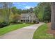 Charming two-story home with lush landscaping, a long driveway, and a welcoming facade at 116 Anderson Farm Ct, Mooresville, NC 28117