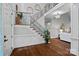 Grand foyer with hardwood floors, elegant staircase, and decorative windows offering a bright, welcoming entrance at 116 Anderson Farm Ct, Mooresville, NC 28117