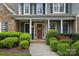 Close up of the front door, adorned with a wreath, and surrounded by manicured landscaping at 116 Anderson Farm Ct, Mooresville, NC 28117