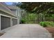 Three-car garage and extra parking with a gated lawn in the background at 116 Anderson Farm Ct, Mooresville, NC 28117