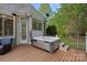 Outdoor hot tub on a wooden deck with a cover and steps for easy access at 116 Anderson Farm Ct, Mooresville, NC 28117