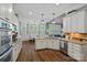 Sunlit kitchen with granite counters, stainless appliances, abundant cabinets, and adjacent breakfast nook at 116 Anderson Farm Ct, Mooresville, NC 28117