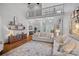 Open-concept living room featuring a soaring ceiling, hardwood floors, and abundant natural light at 116 Anderson Farm Ct, Mooresville, NC 28117