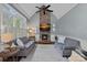 Comfortable living room with a stone fireplace, large windows, and ample seating at 116 Anderson Farm Ct, Mooresville, NC 28117