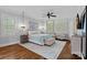 Spacious main bedroom featuring tray ceilings, a ceiling fan, and natural light at 116 Anderson Farm Ct, Mooresville, NC 28117
