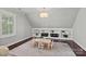 Charming playroom with built-in shelves, a patterned rug, and a small table perfect for activities at 116 Anderson Farm Ct, Mooresville, NC 28117