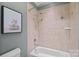 Tiled shower with neutral tile and decor, featuring an overhanging shower head at 116 Anderson Farm Ct, Mooresville, NC 28117