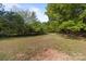 Expansive, grassy backyard surrounded by mature trees, offering privacy at 1238 Moss Springs Rd, Albemarle, NC 28001